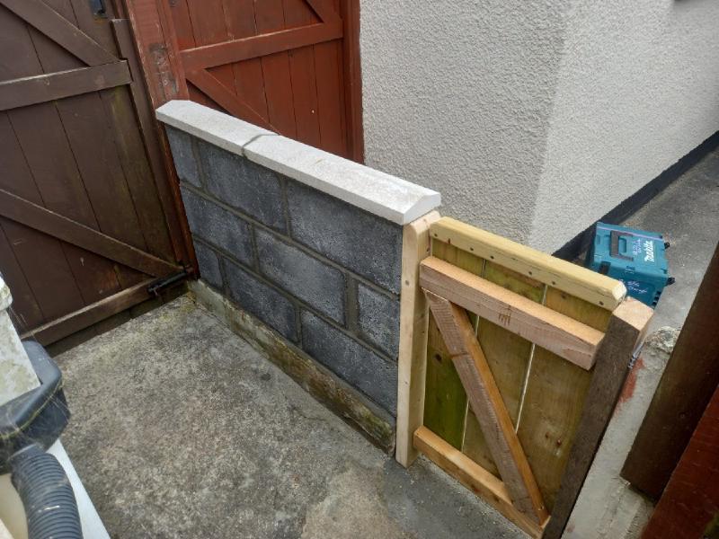 A blockwork wall with attached gate