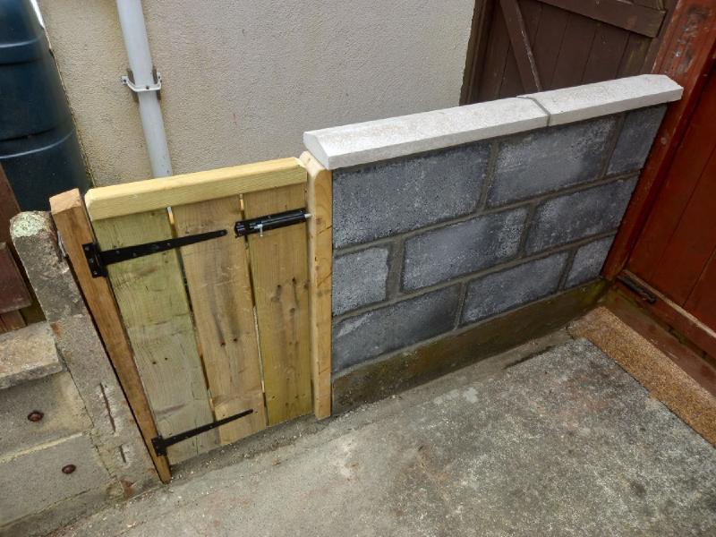 A blockwork wall with attached gate