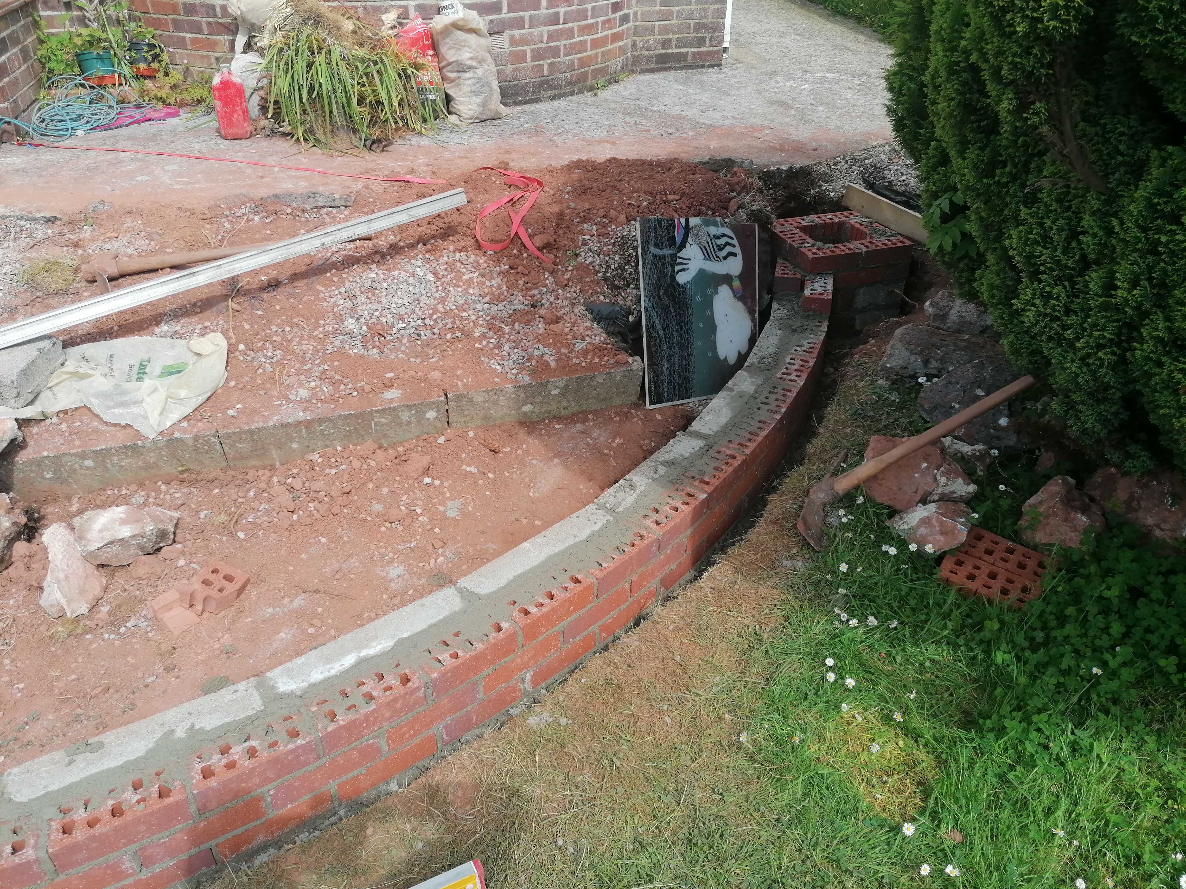 A pier attached to a curved brickwork wall being set out