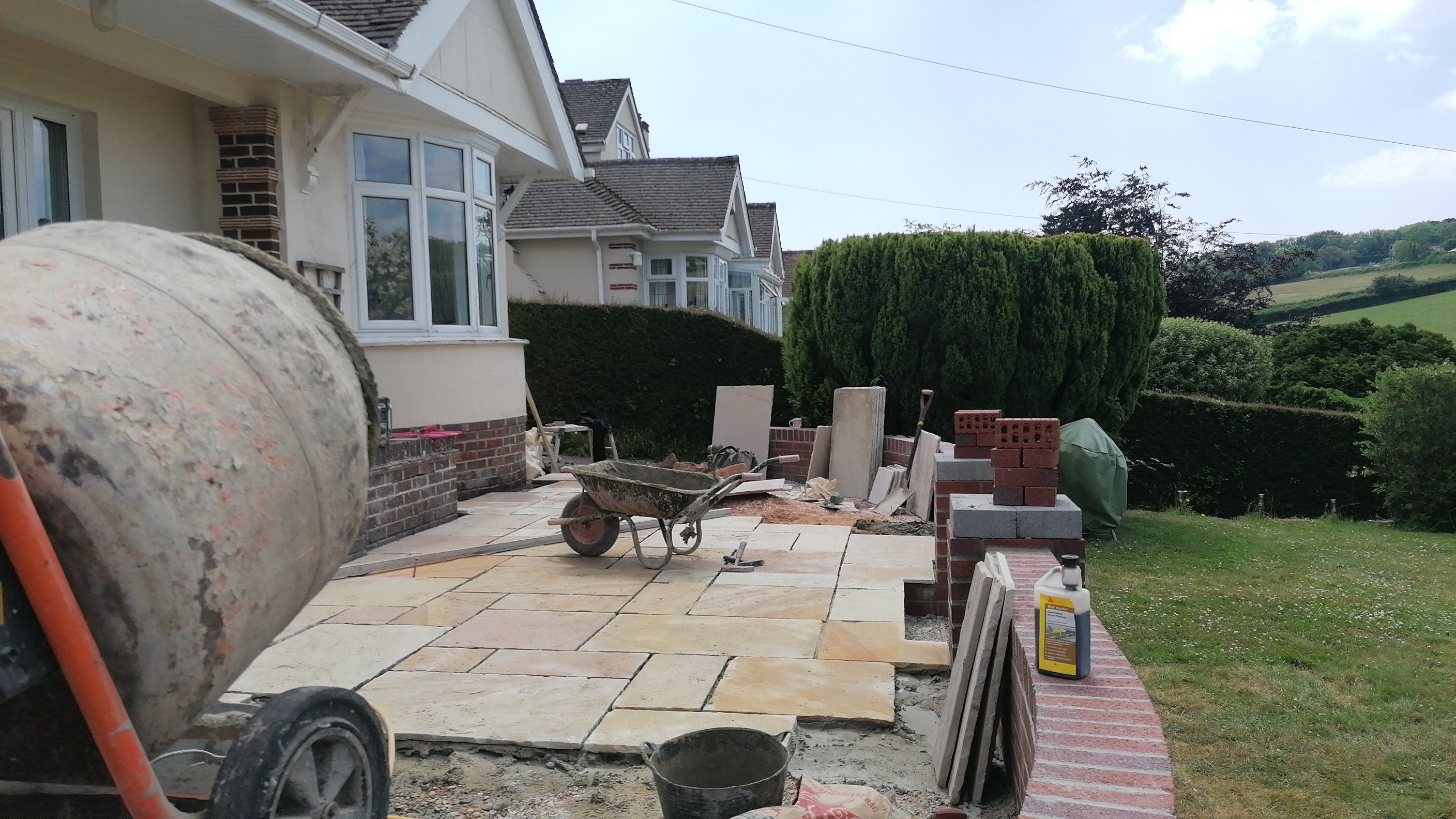 The patio being started beside the curved wall
