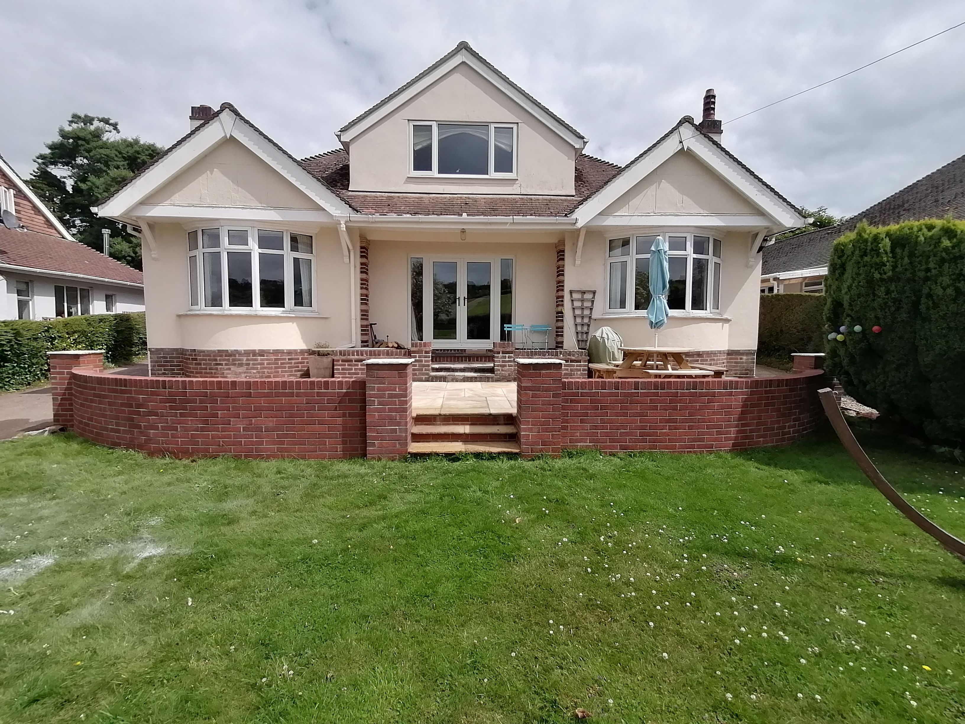 Finished curved brickwork and stone patio slabs