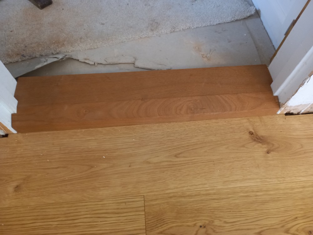 Threshold being fitted to the door